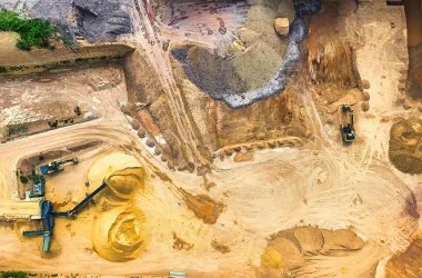 Aerial view of a sand quarry with machinery, showcasing extraction and mining.